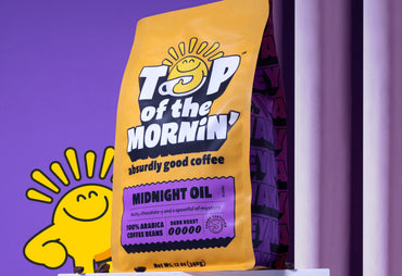 Midnight Oil dark roast coffee nutty and chocolate specialty grade craft coffee with sonny smiling and coffee beans