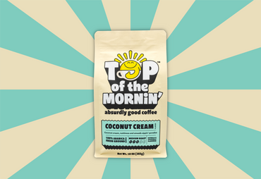top of the mornin' coconut cream coffee tan bag with blue badge front tan and blue background