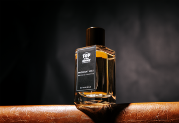 Perfume bottle labeled 'Top of the World' on a dark background