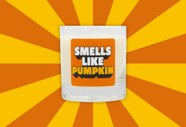 Candle with 'Smells Like Pumpkin' text on a sunburst background