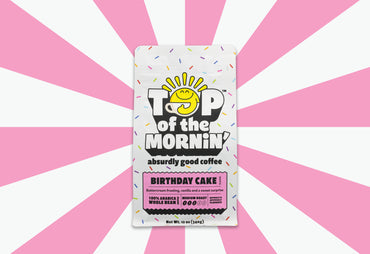 top of the mornin birthday cake coffee bag with sprinkles and pink badge whole bean coffee pink background