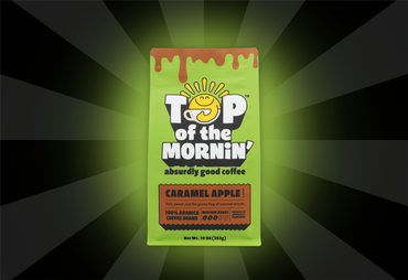 Green coffee package labeled 'Top of the Mornin'' on a dark background