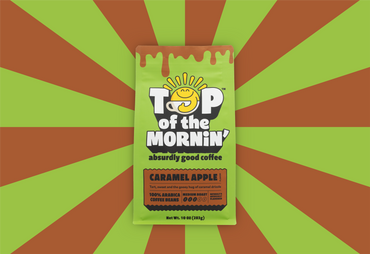 green top of the mornin' coffee bag with orange badge caramel apple flavor front of bag orange and green rays in the background