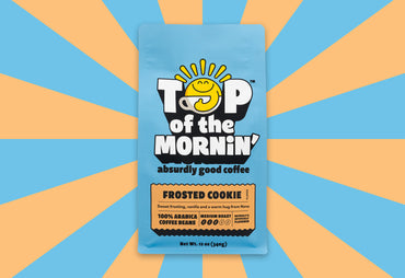 Top of the Mornin' Absurdly good coffee Frosted Cookie Blue and Tan coffee bag on blue and tan background