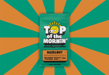 Top of the Mornin' hazelnut coffee package on a green and orange striped background