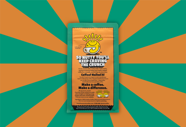 Coffee package with a sun-like logo on a green and orange striped background