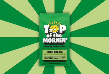 Green coffee package labeled 'Top of the Mornin'' on a green and yellow striped background