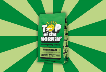 Green coffee bag labeled 'Top of the Mornin'' on a green and yellow striped background
