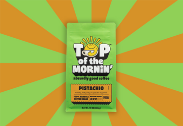 Pistachio flavored coffee package with 'Top of the Mornin'' branding on a green and orange striped background.