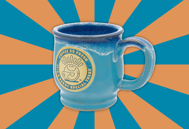 TOTM berry special mug blue mug side of mug blue and orange background